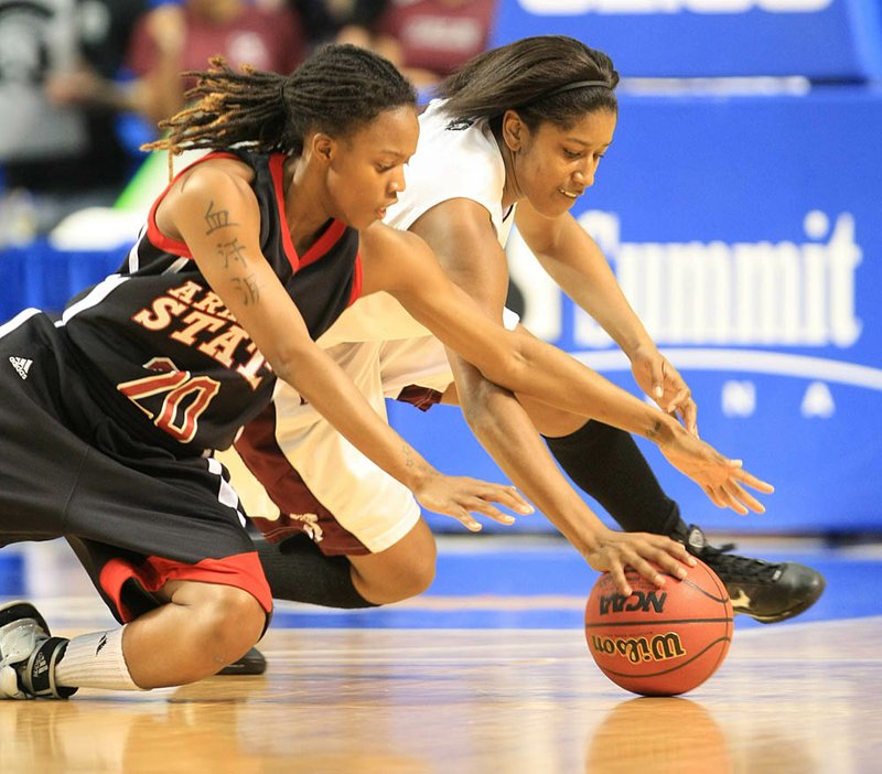 UALR guard Jeanette Merriex, battling for a loose ball with Arkansas State’s Meghan Lewis during a game last season, is hoping to regain her shooting touch for a Trojans team searching for scoring balance behind senior Chastity Reed. 
