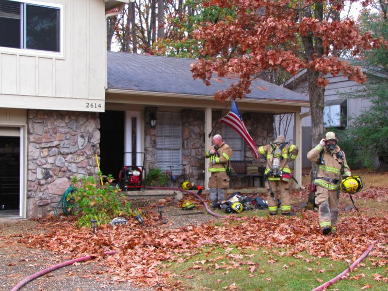 Firefighters work at the scene of a blaze that damaged 2614 Millbrook Road.