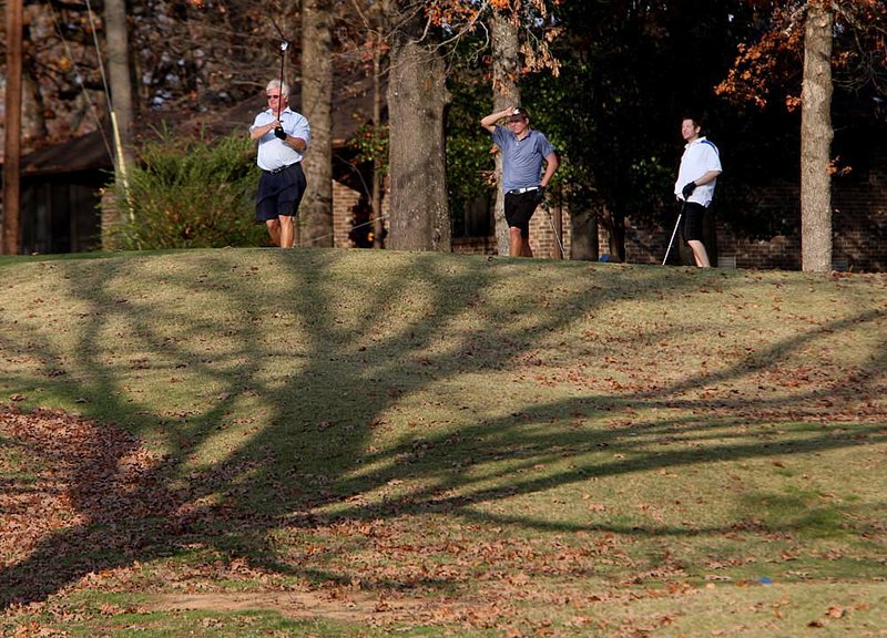Ken Zimmerman (from left), his son, Nick Zimmerman, and Ryan Dillon watch the elder Zimmerman’s drive Wednesday as they golf at The Greens at North Hills in Sherwood. 