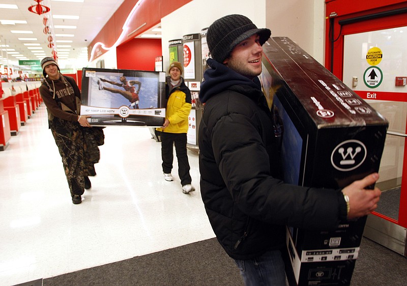Dillon Dyson of Cabot walks out of Target in North Little Rock with his new television during Black Friday shopping, November 26, 2010.