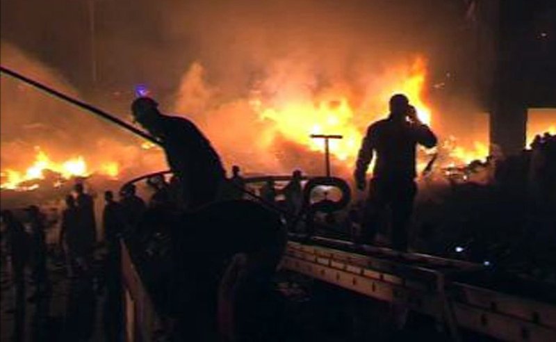 In this image made from TV rescuers are seen at the scene after a cargo plane crashed into a residential area of Karachi, Pakistan's largest city, soon after takeoff Sunday Nov. 28 2010, setting off a huge blaze. The aircraft had eight crew on board, the civil aviation authority said. 