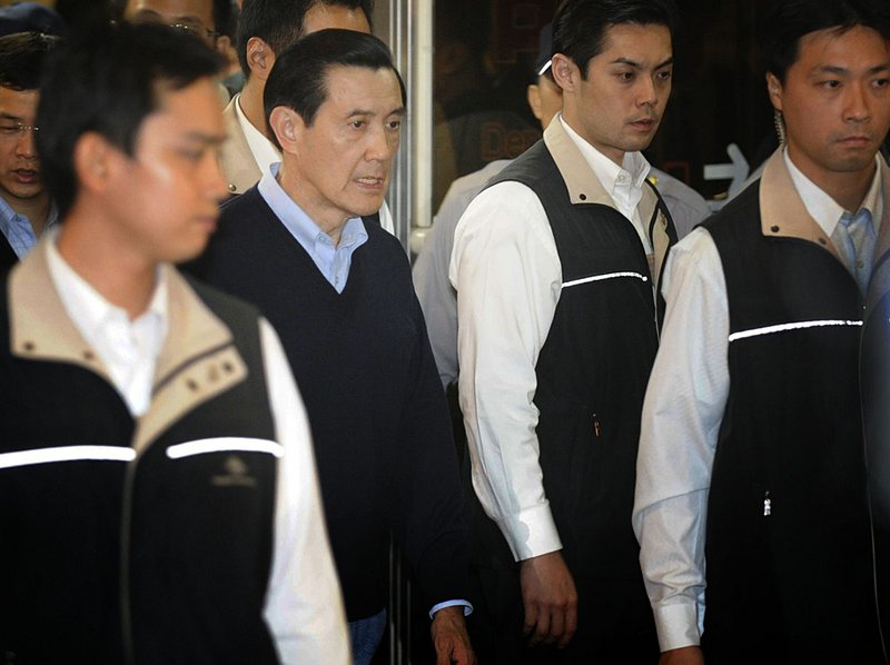 Taiwan President Ma Ying-jeou (second from left) leaves the hospital Friday after looking in on the wounded son of former Taiwanese Vice President Lien Chan. 