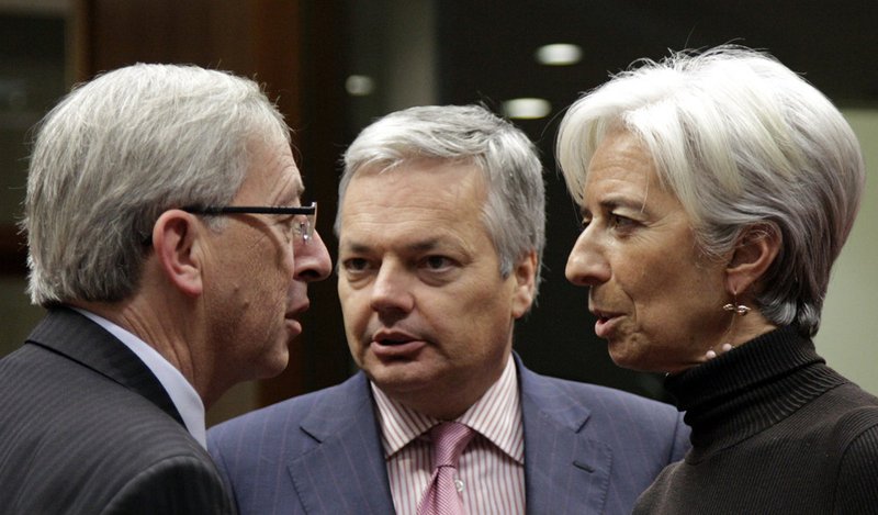 From left, Luxembourg's Finance Minister Jean Claude Juncker, Belgian Finance Minister Didier Reynders and French Finance Minister Christine Lagarde speak during a round table meeting of EU finance ministers at the EU Council building in Brussels on Sunday, Nov. 28, 2010. Finance ministers from the eurozone and the EU met in Brussels Sunday to agree on a financial aid package for Ireland. 