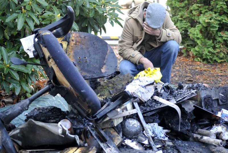 Ahson Saeed, of Corvallis, Ore., reacts over a pile of burnt debris pulled from a local mosque in Corvallis, Ore. Sunday, Nov. 28, 2010 where an alleged arsonist set a fire in the early morning hours. Anger on Sunday over a Somali-born teen's failed plan to blow up a van full of explosives during Portland's Christmas tree lighting ceremony apparently erupted in arson on Sunday when a fire damaged the Islamic center once frequented by the suspect. Police don't know who started the blaze or exactly why, but they believe the mosque was targeted because terror suspect Mohamed Osman Mohamud, 19, occasionally worshipped there.