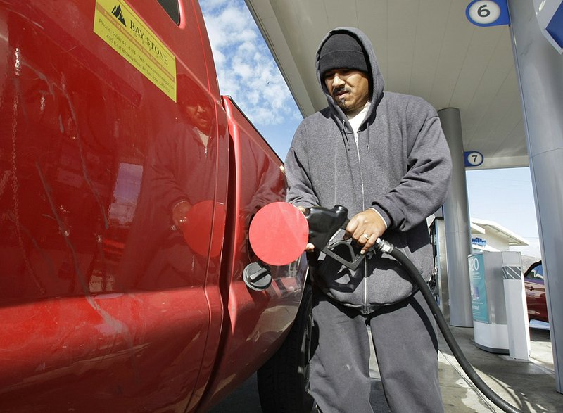 A customer pumps gas at a Chevron station in San Francisco that was selling fuel for $3.55 a gallon Tuesday. More information is available at arkansasonline.com/gas/ 