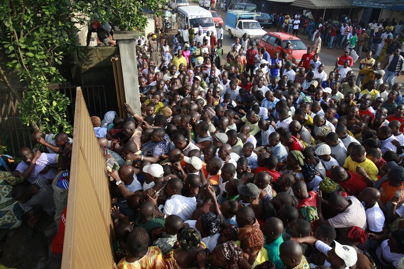 Voters, angry at polls not opening one hour after their scheduled start, break down a gate at Groupe Scolaire Saint Jeanne in the Abobo neighborhood of Abidjan, Ivory Coast, Sunday, Nov. 28, 2010. Ivorians went to the polls Sunday in a long-overdue presidential election that many hope will reunite the country eight years after a civil war divided it in two. Voters are choosing between president Laurent Gbagbo and the man he accuses of being behind the rebellion that sought to topple him, Alassane Ouattara. 