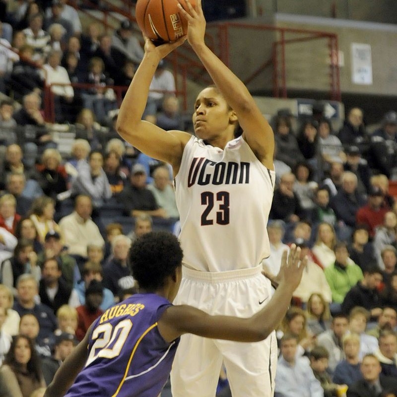 Connecticut’s Maya Moore takes a jump shot over LSU’s Destini Hughes in the Huskies’ 81-51 victory Sunday. 