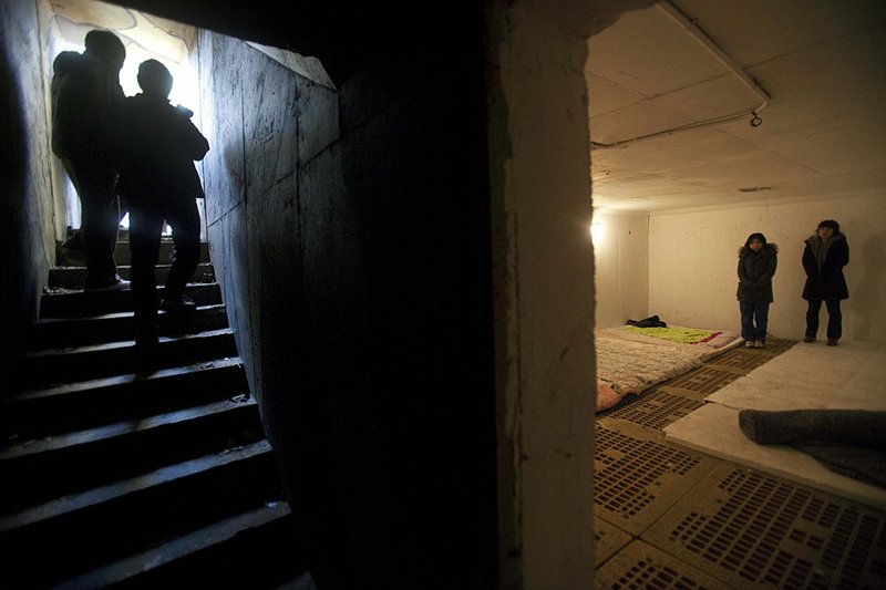 South Korean women take cover inside a bomb shelter on South Korea’s Yeonpyeong Island after authorities sounded the alarm against a possible North Korean rocket attack Sunday. 