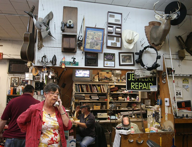 Sue Willard, owner of Sue’s Pawn Shop in Benton, answers a customer’s phone call Wednesday morning. 