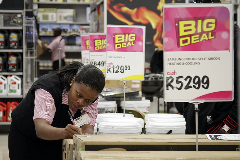An employee stocks at a Game supermarket, part of Massmart Holdings Ltd., earlier this year in Johannesburg, South Africa. 