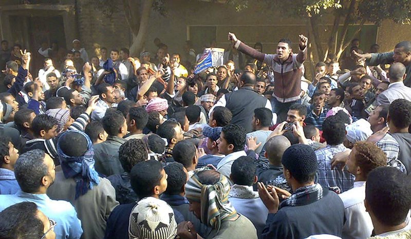 Muslim Brotherhood supporters upset with Sunday’s parliamentary election take to the streets Monday, clashing with riot police firing tear gas, in Qussia, Egypt. 