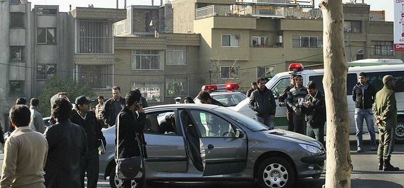 One of the damaged cars in bomb attacks on the vehicles of two nuclear scientists sits in a Tehran, Iran, street, according to Fars News Agency, which released this photo. 