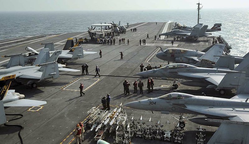 U.S. Navy carrier aircraft are tied down on the flight deck of the USS George Washington during joint military drills off South Korea’s West Sea on Monday. 