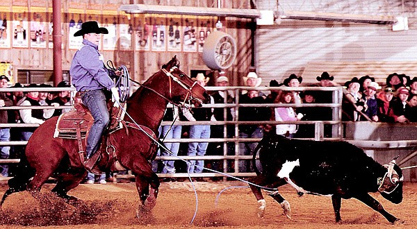 Travis Graves of Jay, Okla., shows off his skill at a rodeo event in February at the Wildfire Ranch Arena in Salado, Texas. Travis is the current money leader among the professional ropers in the PRCA (Professional Rodeo Cowboys Association). He is the son of Ronnie Graves. who said Travis has been working on roping since he was four years old. Travis is married. He and wife Tamika travel extensively to events across the United State in their combination two-horse trailer and living quarters.
