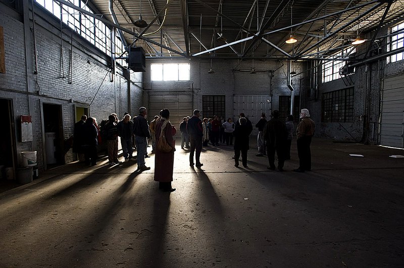 Advocates for the homeless and city officials tour the warehouse section of a building at 1421 E. Ninth St. in Little Rock, which may be turned into a homeless shelter. The building is a former probation office. 