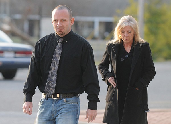 Coleman Brackney, left, former Bella Vista police officer, makes his way to the Benton County Courthouse on Dec. 2 to plead guilty to negligent homicide in connection with the fatal shooting of James Ahern in Bella Vista. Brackney was sentenced to 30 days in jail and a $1,000 fine for the misdemeanor charge.