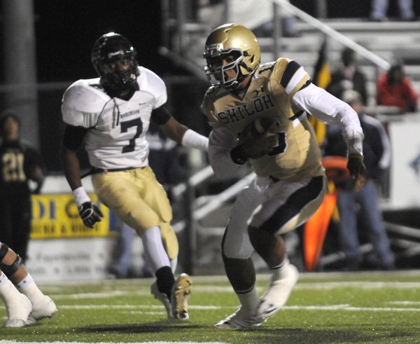 Shiloh Christian senior quarterback Kiehl Frazier runs for a touchdown against Pulaski Robinson during the first half Friday in a semifinal game in the Class 4A State Playoffs in Champions Stadium in Springdale.