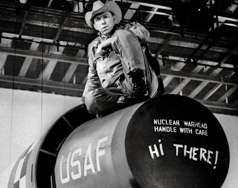 Actor Slim Pickens sits atop a nuclear weapon prop during production of the movie Dr. Strangelove or: How I Learned to Stop Worrying and Love the Bomb directed by Stanley Kubrick. 