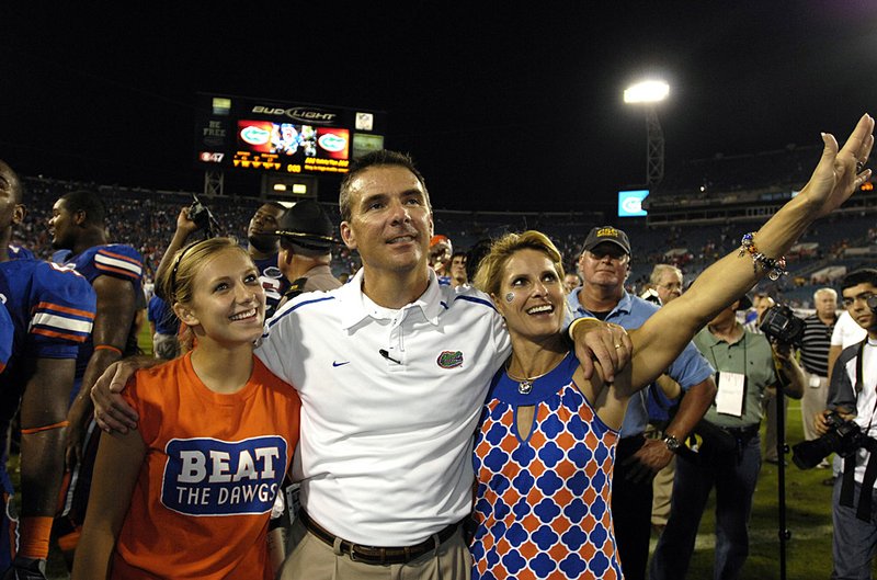 Florida Coach Urban Meyer celebrates a victory with his wife Shelley and daughter Gigi. Meyer said Wednesday he was retiring to spend more time with his family. 