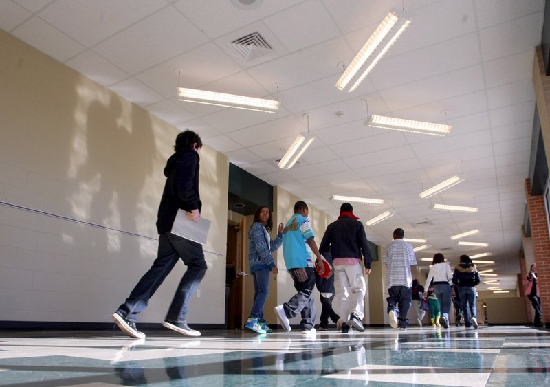 Students dash down the hallway of Forest Heights Middle School's new north classroom building between classes. The 11,570 square foot building opened earlier this month as part of a $5.6 million renovation of the school. 