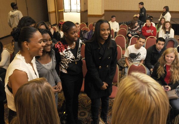 Tulsa Shock WNBA guard and former Olympic athlete Marion Jones, left, talks with several Fayetteville High School students before the Northwest Arkansas Tip-Off Club luncheon Tuesday in the Northwest Arkansas Convention Center in Springdale. Jones spoke of both the highs and lows of her career and the confidence she has in her future.