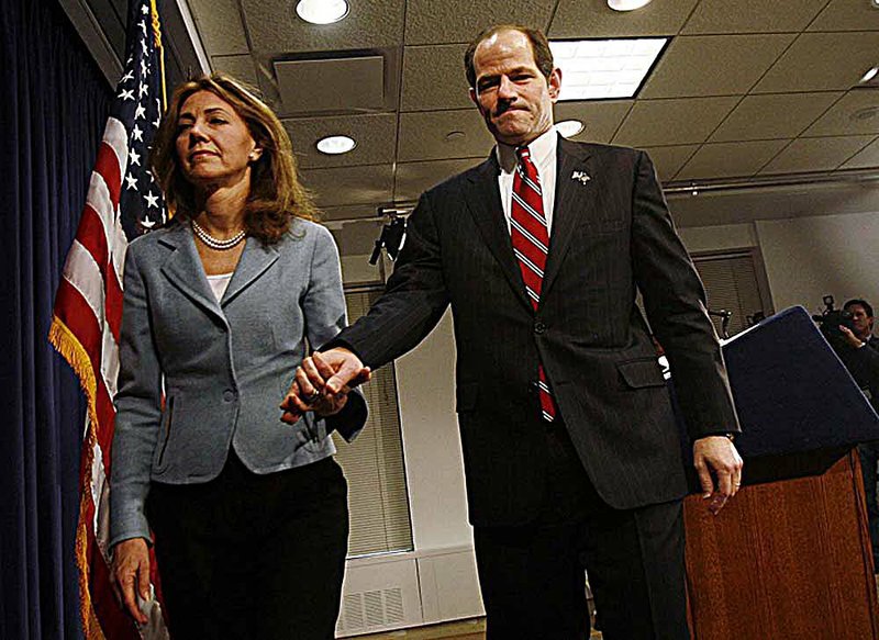 Eliot Spitzer and his wife, Silda Wall, leave a 2008 press conference in which the then-New York governor faced questions about the scandal Alex Gibney dissects in the documentary Client 9: The Rise and Fall of Eliot Spitzer. 