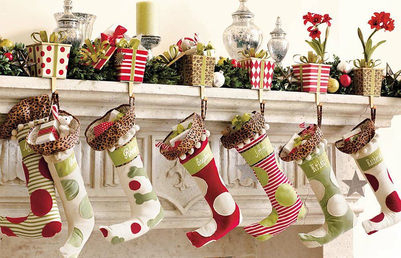 Big polka dots lend a fun element to these Christmas stockings, available with velvet appliques on ivory duck or ivory duck on velvet. The faux fur “collars” draw smiles. They may be personalized. Each sells for $29; see at ballarddesigns.com. Gift-box stocking holders are handpainted metal in French tole styles. They’re open at the top so a surprise can go inside. Choose from harlequin, polka dot, cheetah or stripe. 