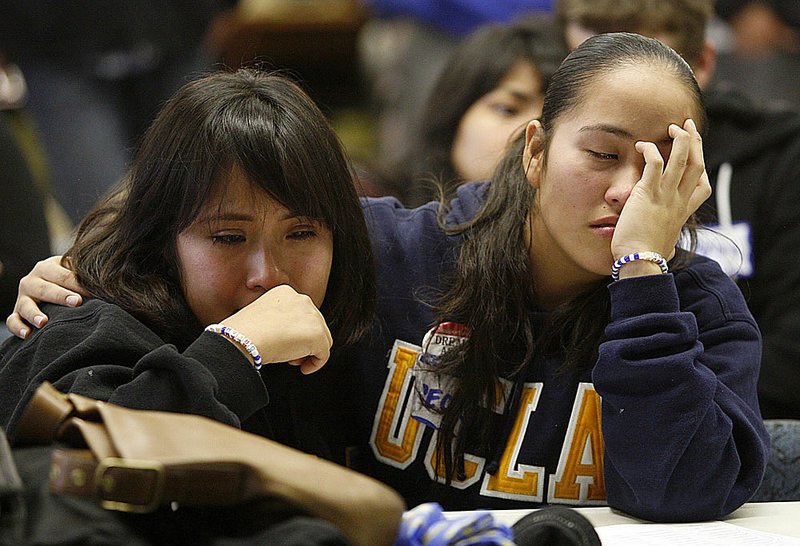 Illegal aliens Leslie Perez (left) and Grecia Mondragon, both students at the University of California, Los Angeles, watch televised coverage of Saturday’s immigration vote in the Senate.