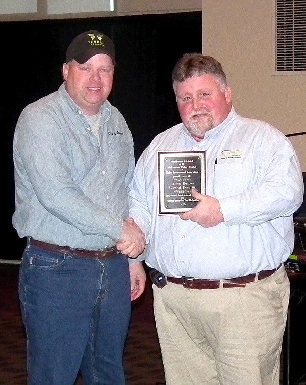 William Winn, of the Northwest District of the Arkansas Water Works and Water Environment Association, presented James Boston, Decatur's director of public works, with an award for wastewater operator of the year for cities under 5,000 people on Wednesday. Boston will go on to compete for the state award against eight other water districts next April.