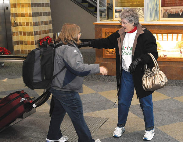Edith Griffen, right, greets Lanell Allen at Northwest Arkansas Regional Airport on Christmas Eve in Bentonville. Allen had just arrived from Fort Worth, Texas, to find a relatively uncrowded airport on the day before Christmas.