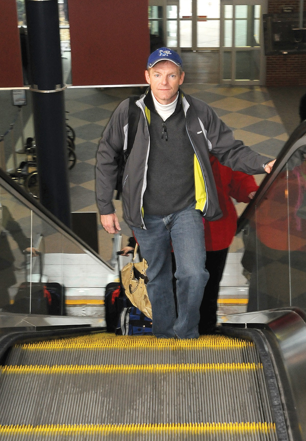 Eric Harris departs for Memphis, Tenn., from Northwest Arkansas Regional Airport on Christmas Eve in Bentonville. Harris found lines short and departing passengers few on the day before Christmas.