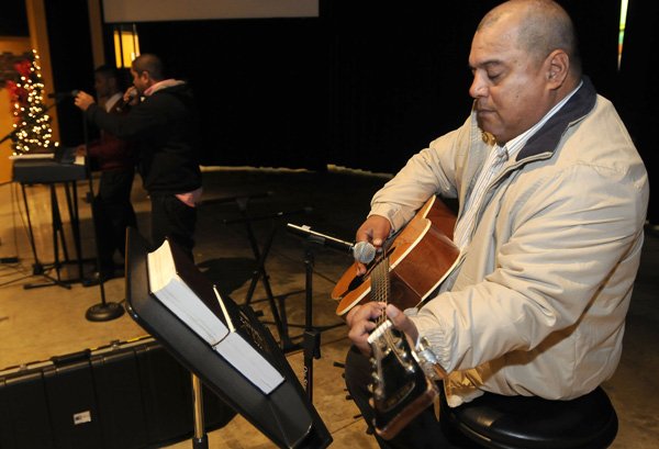 Larry Muller, of Lowell, plays the guitar Dec. 12 at the Cross Church Marshallese service in Springdale. The special service for the group started in May with a home group.