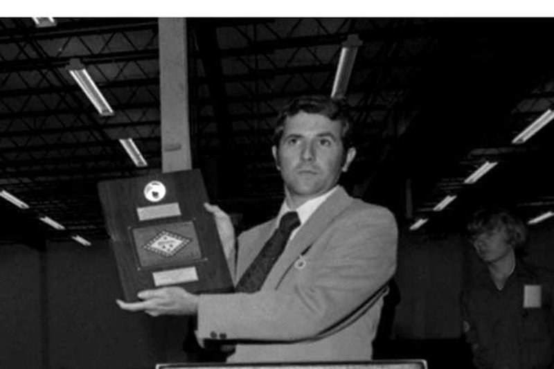 Astronaut Richard H. Truly holds a plaque displaying a moon rock and a small Arkansas flag that he presented to the state in 1976 at a Boy Scout event in Little Rock.

 