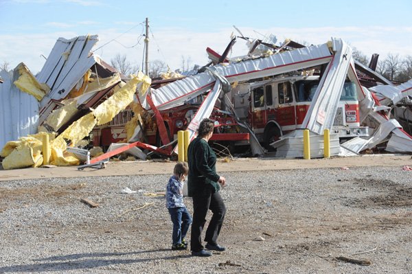 Residents walk past the Lincoln-Cincinnati fire station after it was destroyed on Friday, Dec. 31, 2010, in Cincinnati. A tornado ripped through the small community around 6:00 a.m., causing at least three fatalities.