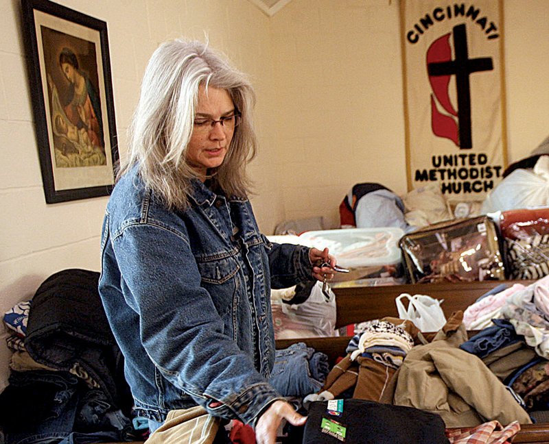 Sharon Davis of Cincinnati, a victim of Friday’s tornado, picks up some clothes Tuesday at the United Methodist Church.