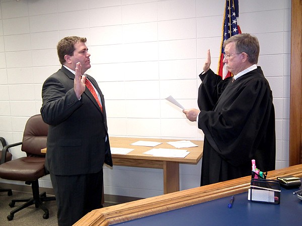 Gravette Mayor Byron Warren takes his oath of office before Judge Jay Finch.