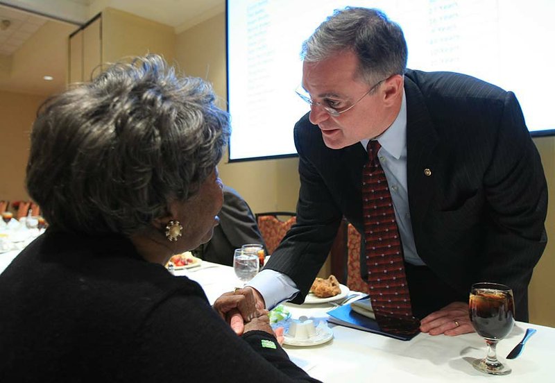 U.S. Sen. Mark Pryor (right) visits with Annie Abrams during a luncheon Tuesday at the Doubletree Hotel in Little Rock. Pryor spoke to the Rotary Club about the need to control federal spending. 