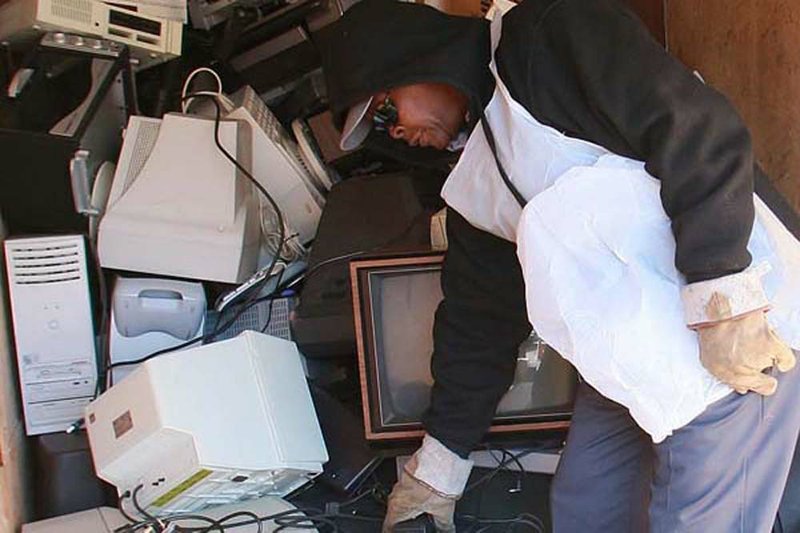 Robert Davis, with Little Rock Public Works, loads electronics Thursday into a truck trailer after the items were dropped off for recycling at the Little Rock Northwest Police Substation. 