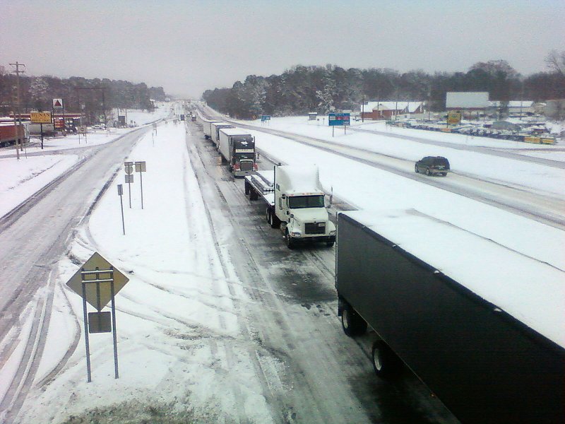 Trucks are parked in the I-30 west bound lanes at the Sevier St. exit in Benton Monday morning.  