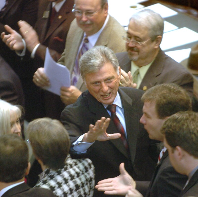  Gov. Mike Beebe greets legislators Tuesday after taking the oath of office in the House of Representatives at the state Capitol in Little Rock. 