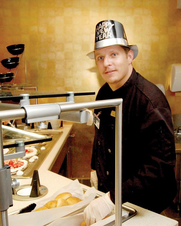 Chef Richard Davis arranges the buffet at Lagniappe's inside Oaklawn Park.