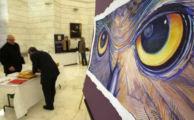 Representatives of various organizations gather inside the state Capitol, vying for legislators’ attention. One display Wednesday included artwork by artist Sven Svenson. 