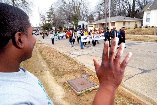 Jeremy Marshall waves to participants along Main Street in Arkadelphia during the 2010 MLK “Marade.”