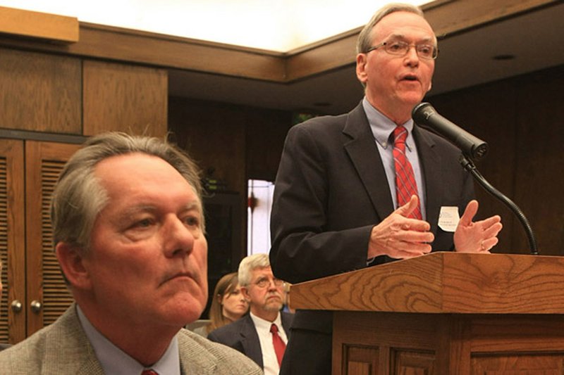 With Sam Jones, attorney for the Pulaski County Special School District, seated beside him Friday, Michael Ronan, president of Lighthouse Academies, speaks to the Arkansas Board of Education. 