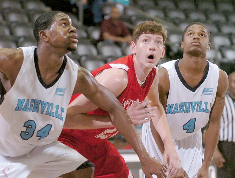 Arkansas Wings Elite 17 forward Hunter Mickelson is sandwiched between two Nashville Celtics as they prepare to get a rebound in their basketball game in the 17 and under boys division at the Jack Stephens Center on the UALR campus during April’s Real Deal  in the Rock.