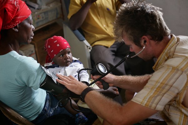 Dr. Clayton Bell of Searcy takes the blood pressure of a Haitian woman at the Cloud Forest Medical Clinic in Seguin, Sud-Est, Haiti.