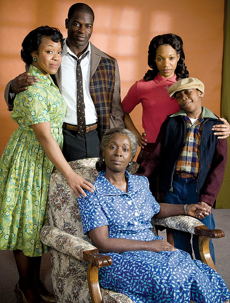 The cast of The Rep’s A Raisin in the Sun includes (clockwise from left) Lynnette R. Freeman as Ruth Younger, Hisham Tawfiq as Walter Lee Younger, Myxolydia Tyler as Beneatha Younger, Tyrese Treyvon Bluford as Travis Younger and Phyllis Yvonne Stickney as Lena Younger.

