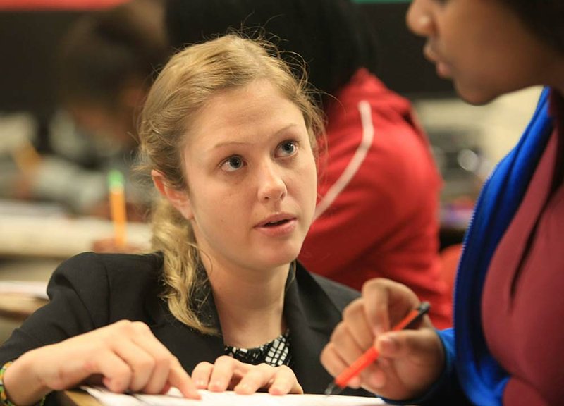 Teach for America teacher Mary Quinn helps a student Thursday at Pine Bluff High School. 