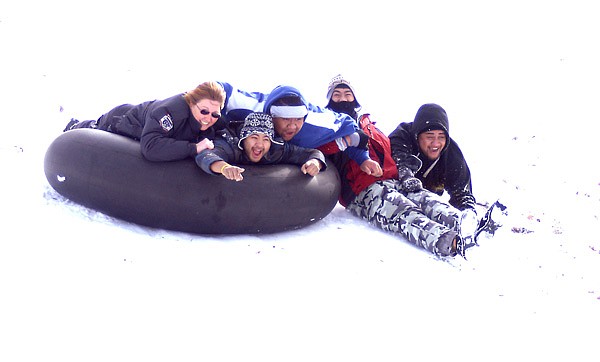 Enjoying the cold and snow | Gentry police officer Rachelle Raimer joins Tevita Vunileva, Anthony Vunileva, Karlo Pasco and Nelson Fuentes for one ride down a hill at Ozark Adventist Academy in Gentry Thursday morning following the snow which fell in the early morning hours. Public schools in the area were closed on Thursday and Friday because of the snowfall and resulting slippery roads. Approximately 3-5 inches fell in the area. The official Gravette total was 3.2 inches.