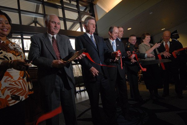 Pearl Gordon, from left, former Jacksonville Mayor Tommy Swaim, Gov. Mike Beebe, Jacksonville Mayor Gary Fletcher, Little Rock Air Force Base commander Col. Michael Minihan, Col. Glen Masset, Melody Toney and Mike Wilson cut the ribbon Wednesday for the Jacksonville-Little Rock Air Force Base University Center.